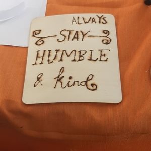 Wooden sign that says always stay humble and kind